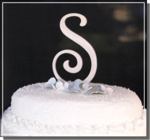 Brushed aluminum monogram cake topper on a contemporary wedding cake top